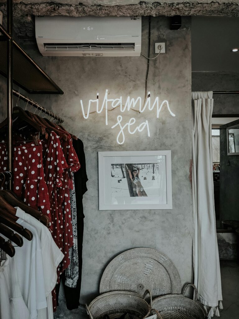 Chic Bali boutique featuring fashion items, a neon 'Vitamin Sea' sign, and bohemian decor.